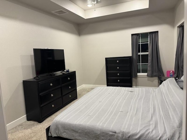 bedroom featuring visible vents, baseboards, and light colored carpet