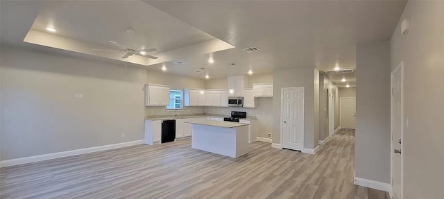 kitchen featuring a ceiling fan, white cabinets, visible vents, black appliances, and a center island
