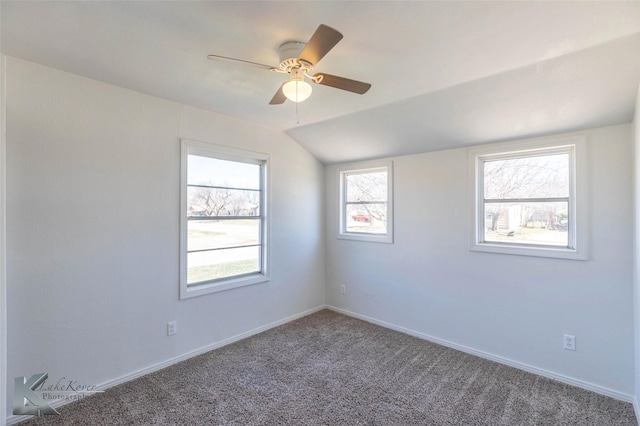 unfurnished room with lofted ceiling, carpet, baseboards, and ceiling fan