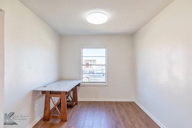 office area with baseboards and wood finished floors