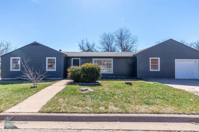 ranch-style house with concrete driveway, an attached garage, and a front lawn