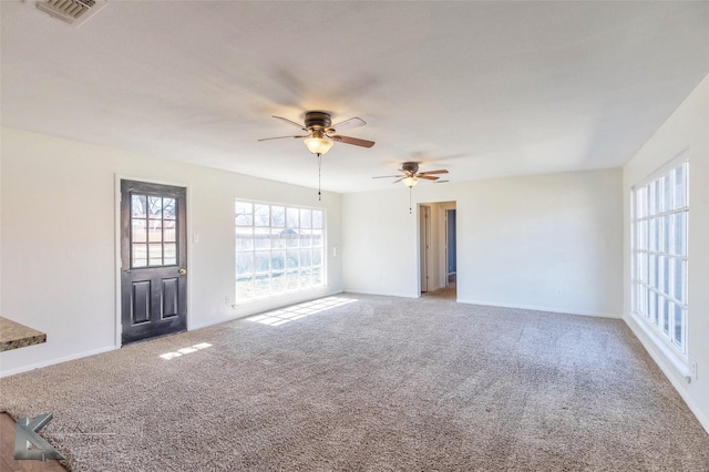 unfurnished room featuring a ceiling fan, light colored carpet, and visible vents