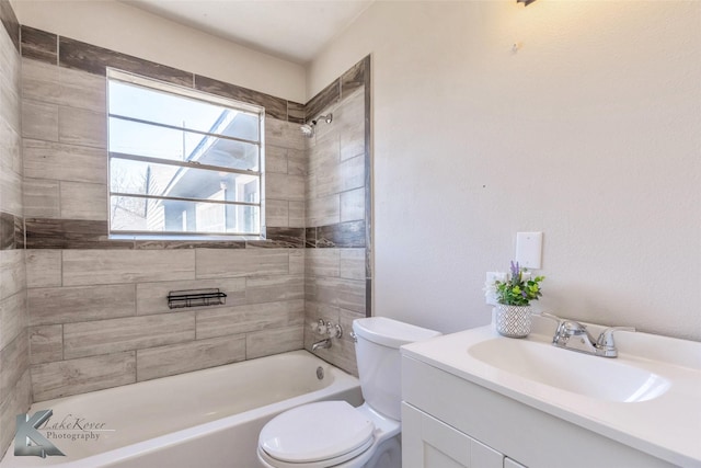 full bathroom featuring washtub / shower combination, vanity, and toilet