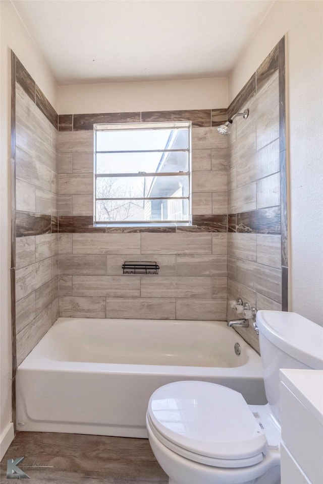 bathroom with tub / shower combination and toilet