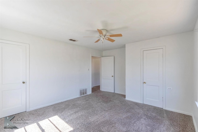 unfurnished bedroom featuring a ceiling fan, carpet flooring, visible vents, and baseboards