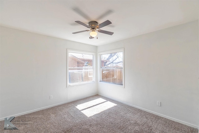 spare room featuring carpet flooring, a ceiling fan, and baseboards