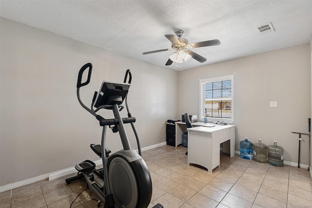 workout room featuring light tile patterned floors, visible vents, a ceiling fan, a textured ceiling, and baseboards