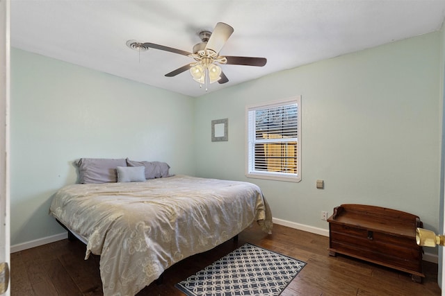 bedroom featuring a ceiling fan, baseboards, and wood finished floors