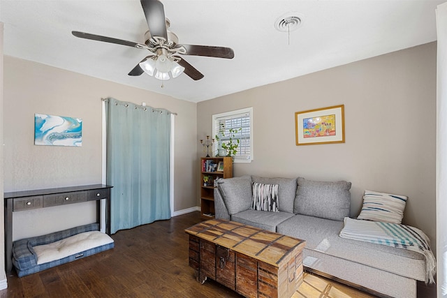 living area with baseboards, visible vents, a ceiling fan, and wood finished floors