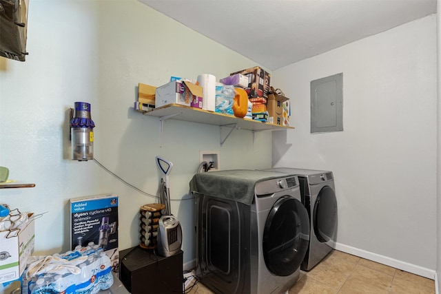 laundry area featuring laundry area, electric panel, baseboards, independent washer and dryer, and light tile patterned flooring