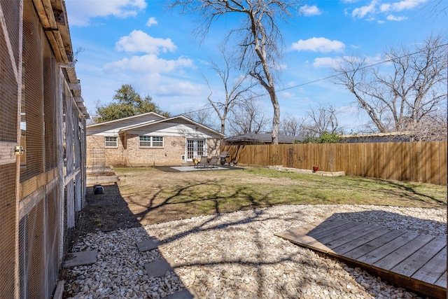 view of yard featuring a patio, a fenced backyard, and a wooden deck