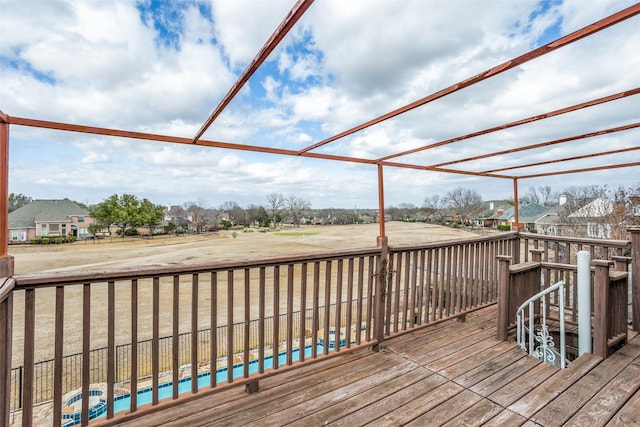 wooden terrace featuring a residential view and an outdoor pool