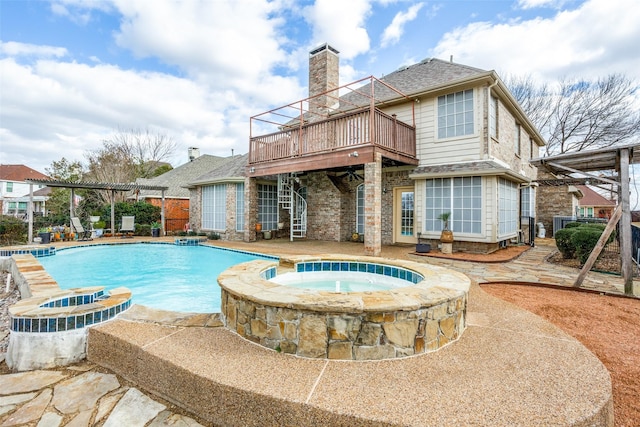 view of pool featuring a deck, a patio, and a pool with connected hot tub