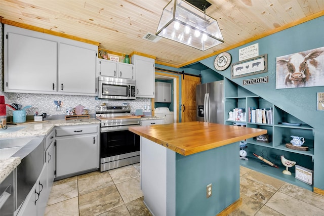 kitchen with wood ceiling, a barn door, visible vents, and appliances with stainless steel finishes