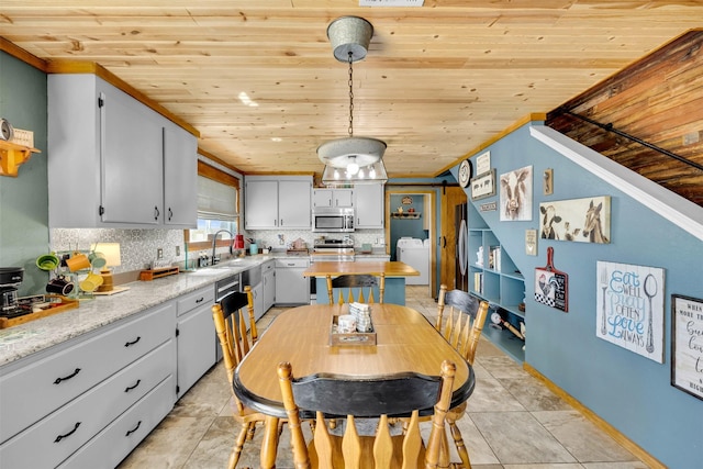 dining space with wooden ceiling, light tile patterned floors, and washer / clothes dryer