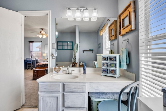 bathroom featuring a ceiling fan, connected bathroom, and vanity