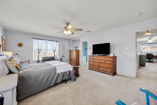 bedroom with ceiling fan, multiple windows, visible vents, and light colored carpet