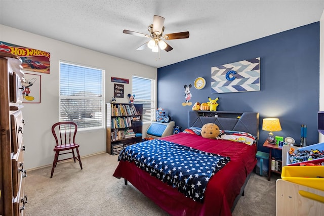 bedroom featuring a textured ceiling, ceiling fan, and carpet flooring