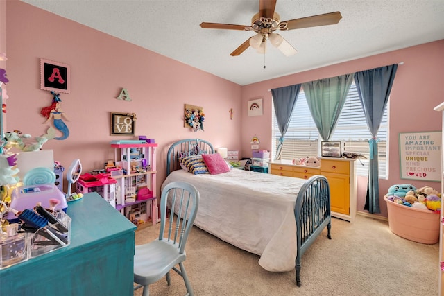 bedroom with light carpet, ceiling fan, and a textured ceiling