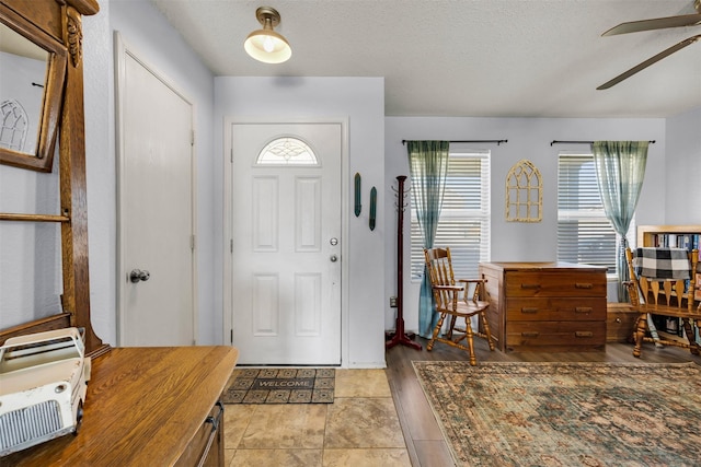 entrance foyer with a textured ceiling and a ceiling fan