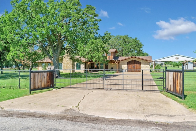 view of front of house with a front yard, a gate, and brick siding