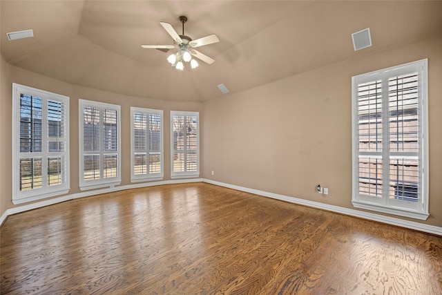 unfurnished room with plenty of natural light, wood finished floors, and visible vents