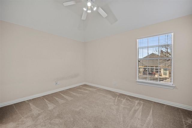 unfurnished room featuring lofted ceiling, ceiling fan, baseboards, and carpet flooring