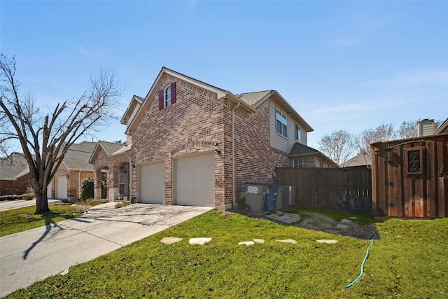 view of side of home featuring a lawn, concrete driveway, an attached garage, fence, and brick siding