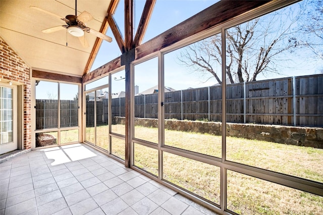 unfurnished sunroom with vaulted ceiling and ceiling fan