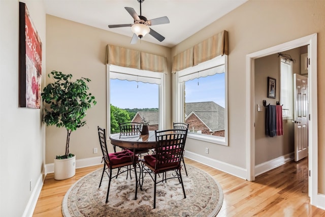 dining room with light wood-type flooring, ceiling fan, and baseboards