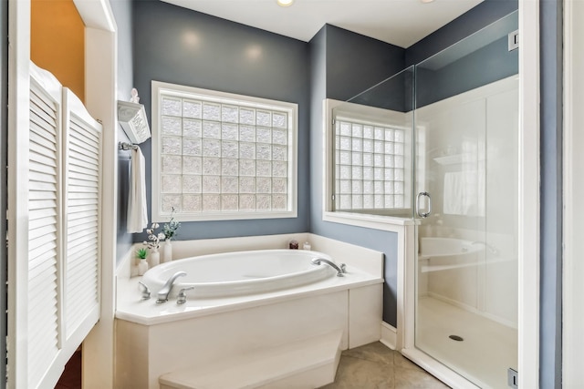 full bathroom with a stall shower, tile patterned flooring, and a garden tub