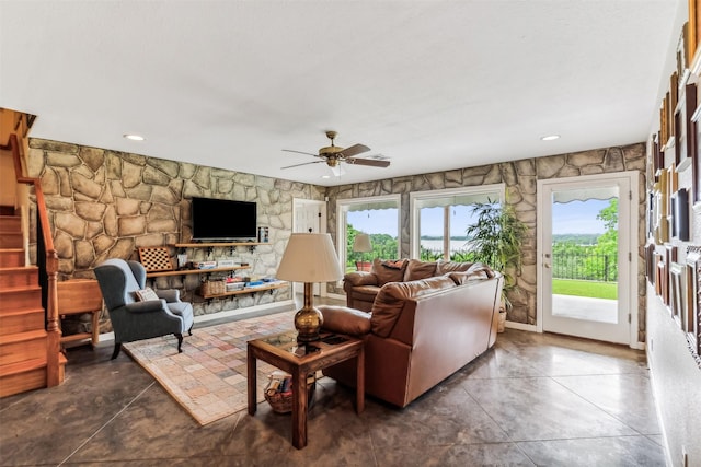 living area with a healthy amount of sunlight and ceiling fan