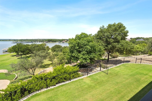 view of yard with a water view and fence