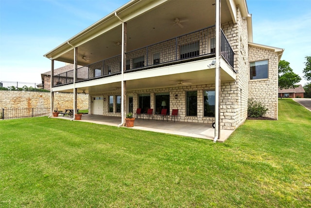 back of property with a patio, a yard, and fence