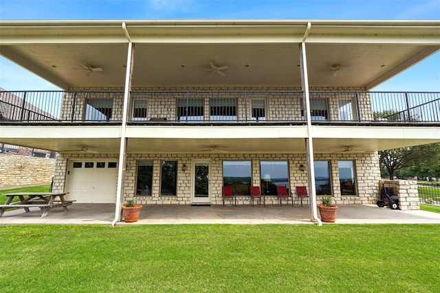 rear view of property featuring a patio, a lawn, and a ceiling fan