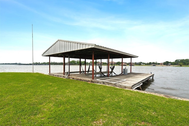 dock area with a yard and a water view