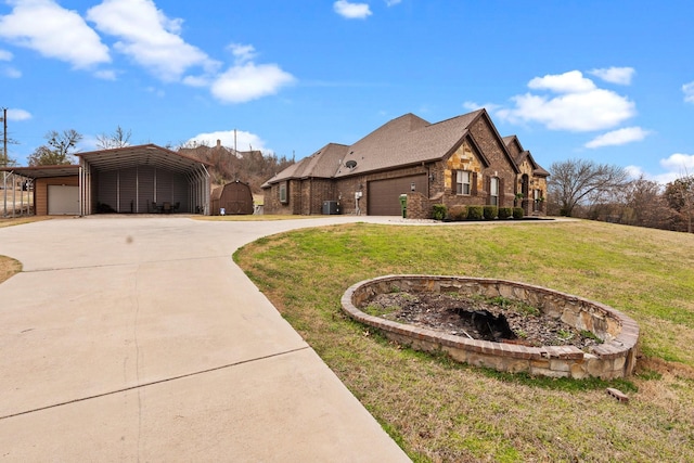 french provincial home with concrete driveway, a front lawn, brick siding, and central air condition unit