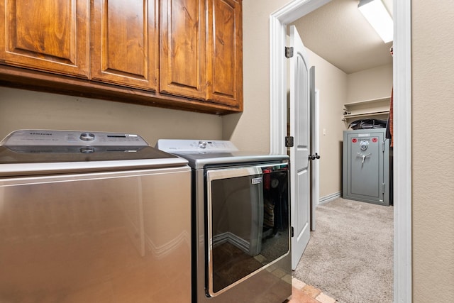 laundry area with light carpet, cabinet space, and independent washer and dryer