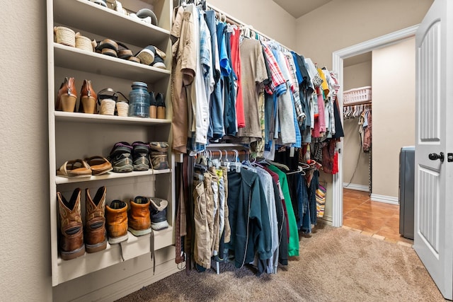 spacious closet with carpet floors and tile patterned flooring