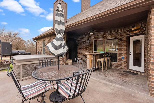 view of patio featuring a ceiling fan and outdoor dry bar