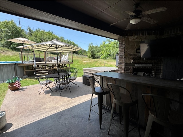 110 Bolivar Dr, Weatherford, TX 76085 - view of patio / terrace with a bar, a ceiling fan, outdoor dining area, and an outdoor pool