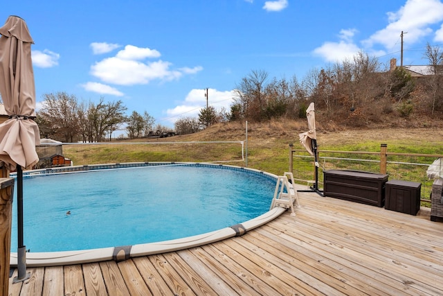 pool featuring a deck and a yard