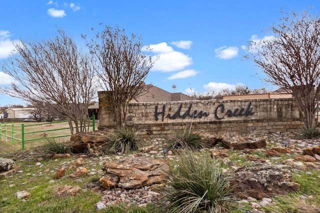 community sign featuring fence