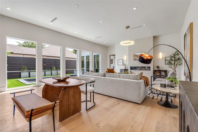 living room featuring recessed lighting, visible vents, and light wood-style flooring