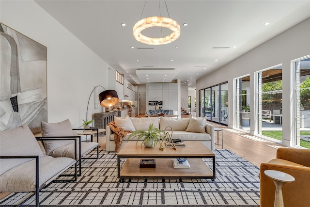 living area featuring stairway, wood finished floors, and recessed lighting