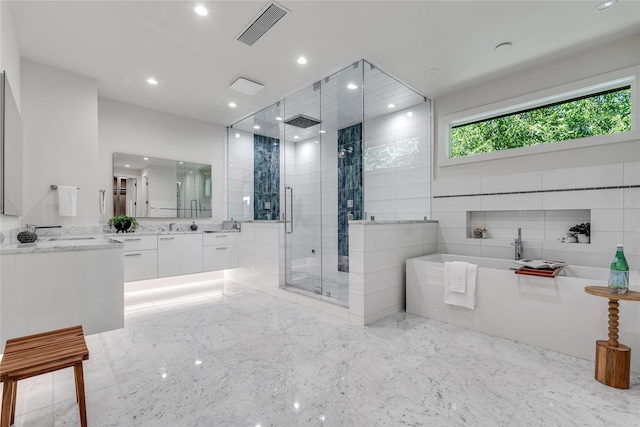 full bathroom with recessed lighting, visible vents, a stall shower, vanity, and a freestanding tub