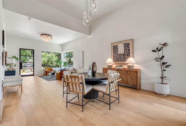 dining room with a notable chandelier, light wood finished floors, recessed lighting, and baseboards