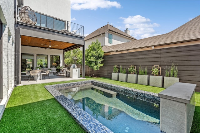 view of swimming pool featuring a lawn, a hot tub, a ceiling fan, a patio area, and a fenced backyard