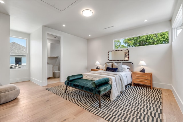 bedroom with attic access, recessed lighting, light wood-style flooring, and baseboards