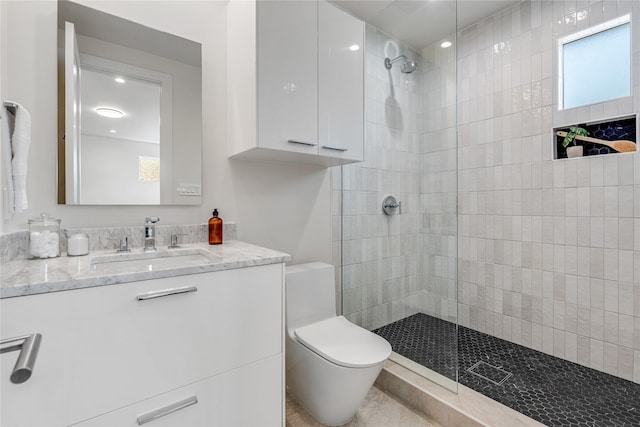 bathroom with vanity, toilet, and a walk in shower